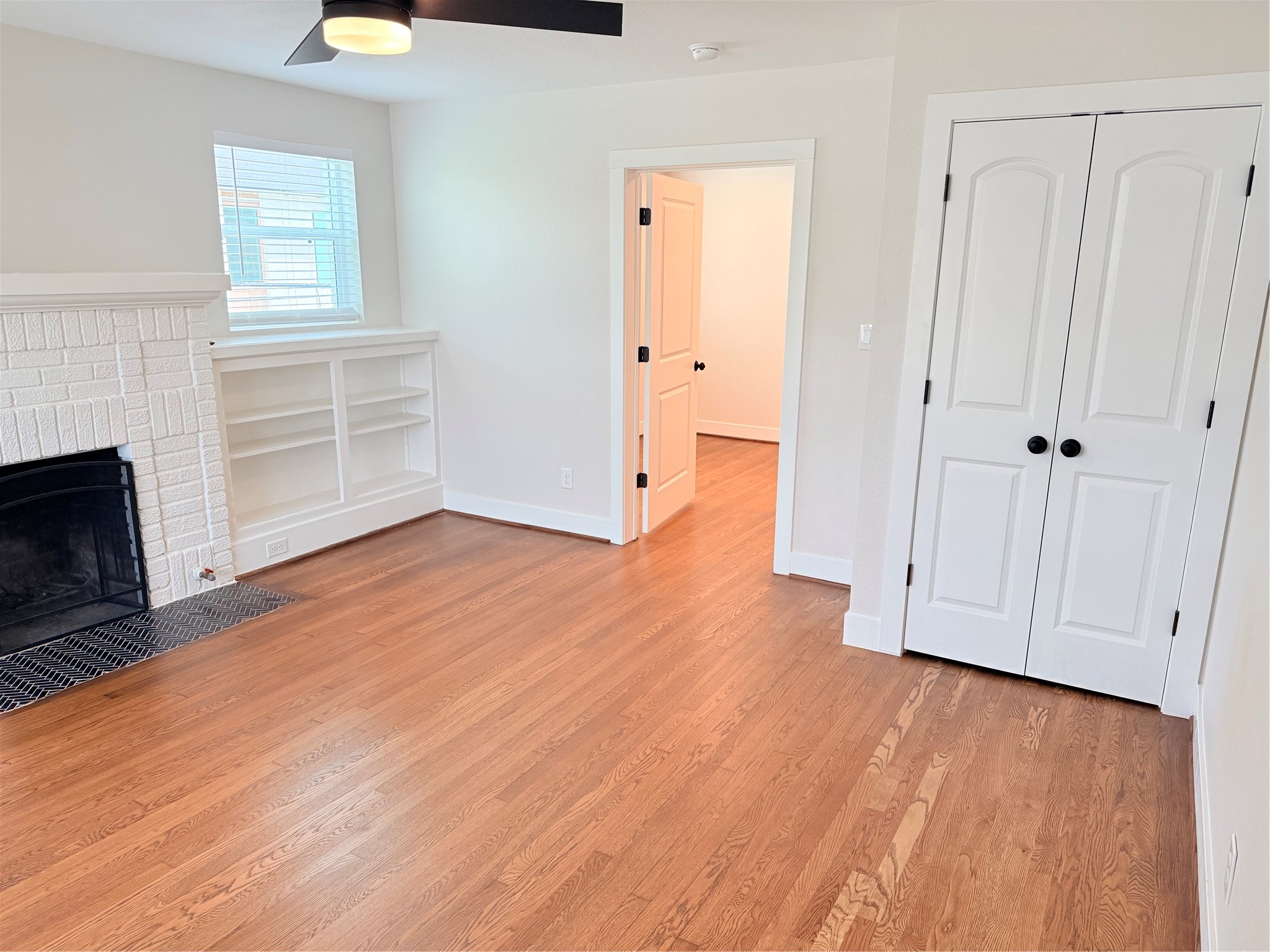 2001 Brun Street, Unit 1 Houston, TX 77019 - Photo 2 of 15 a view of empty room with wooden floor and fireplace