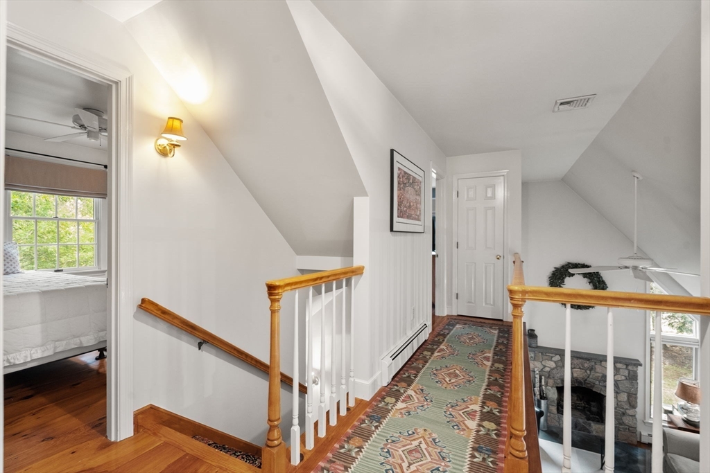 9 Arbor Circle Natick, MA 01760 - Photo 17 of 34 a view of a hallway with windows and wooden floor