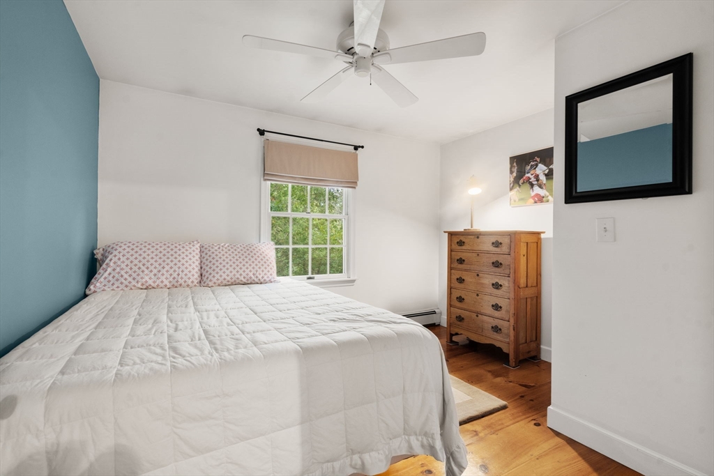 9 Arbor Circle Natick, MA 01760 - Photo 22 of 34 a bedroom with a bed and a flat tv screen on dresser