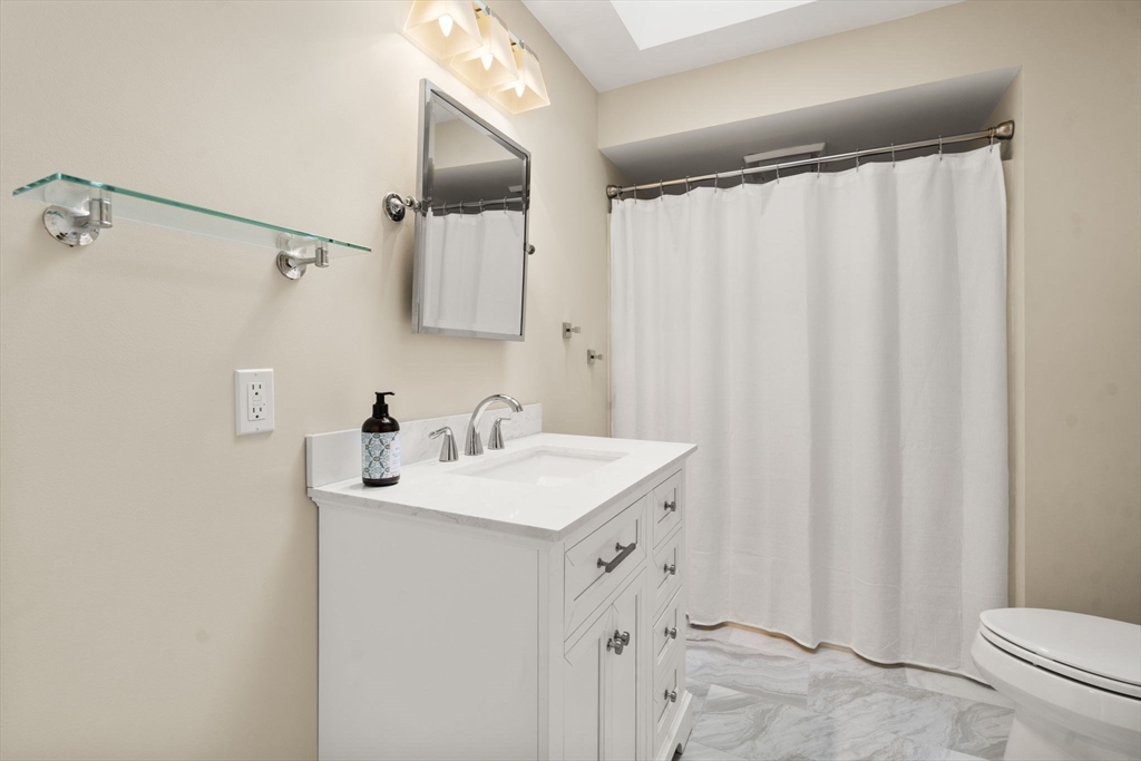 9 Arbor Circle Natick, MA 01760 - Photo 23 of 34 a bathroom with a sink a toilet and a mirror