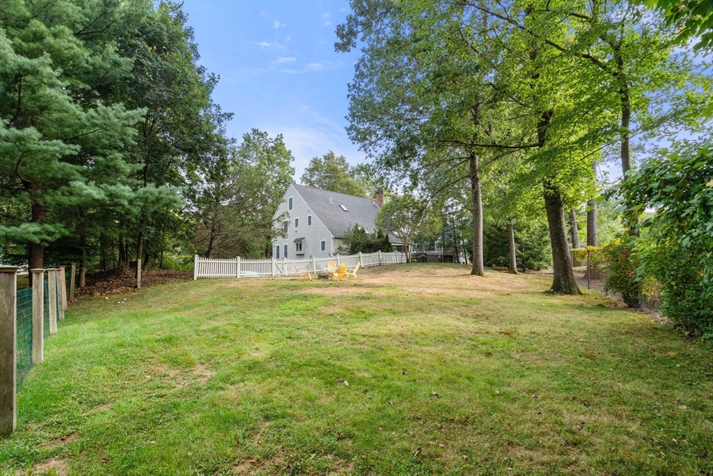 9 Arbor Circle Natick, MA 01760 - Photo 32 of 34 a backyard of a house with table and chairs