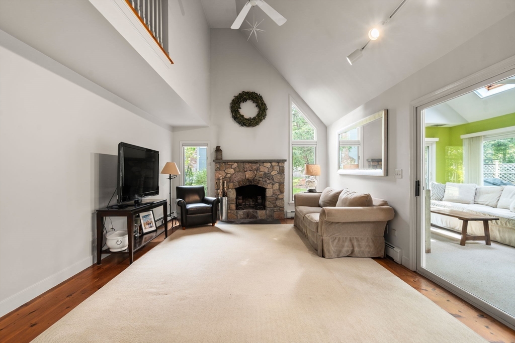 9 Arbor Circle Natick, MA 01760 - Photo 8 of 34 a living room with furniture a fireplace and a flat screen tv