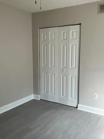 an empty room with wooden floor