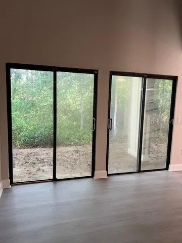 a view of an empty room with large windows