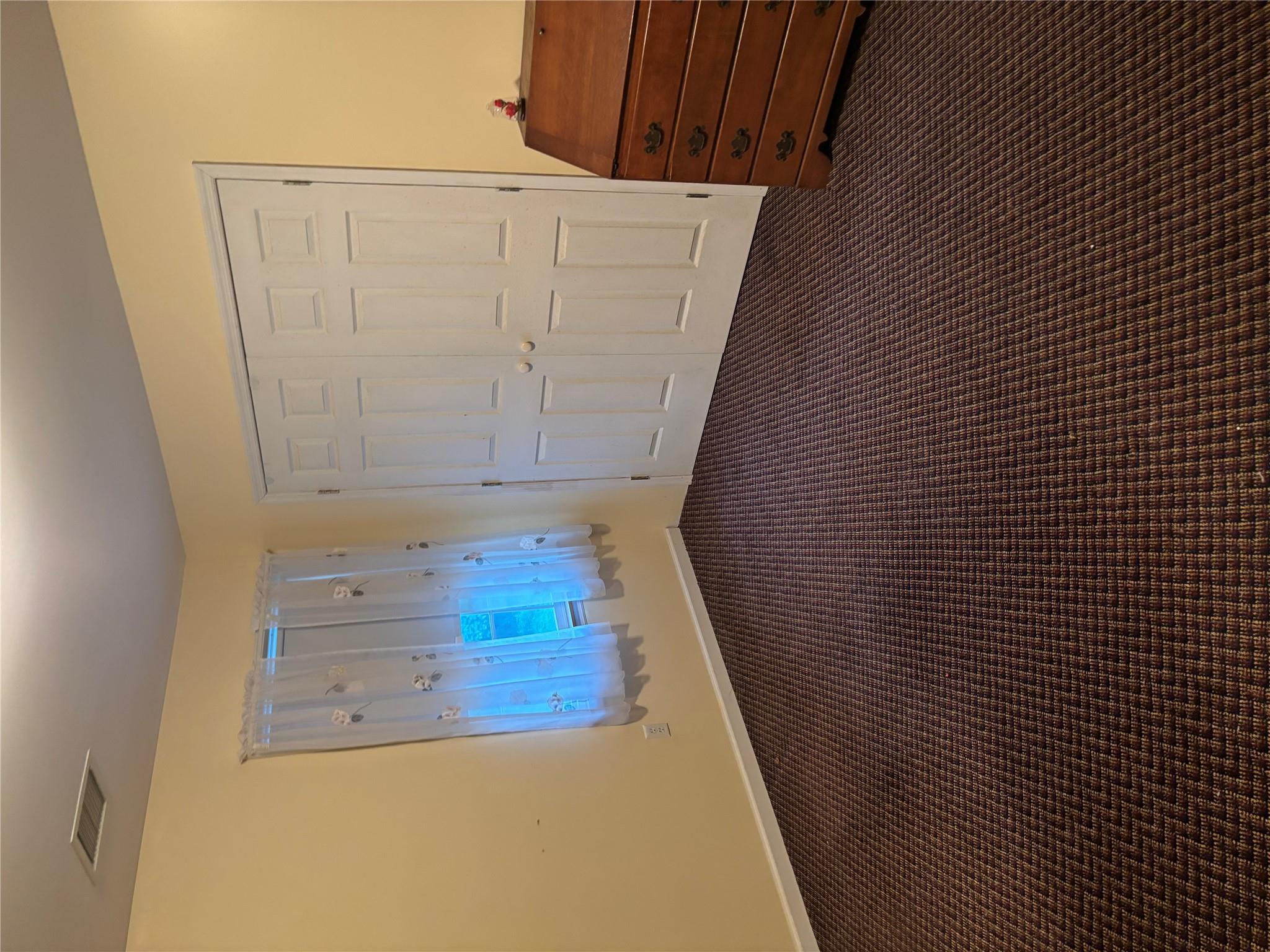 60 Randall Road Wading River, NY 11792 - Photo 11 of 14 a view of an empty room with wooden floor