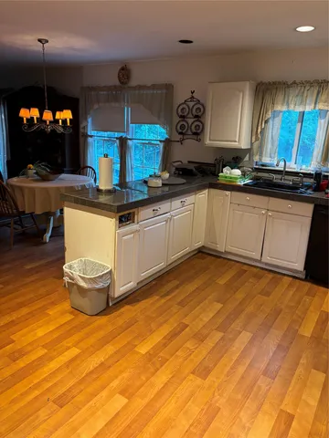 a kitchen with stainless steel appliances granite countertop a sink and a stove