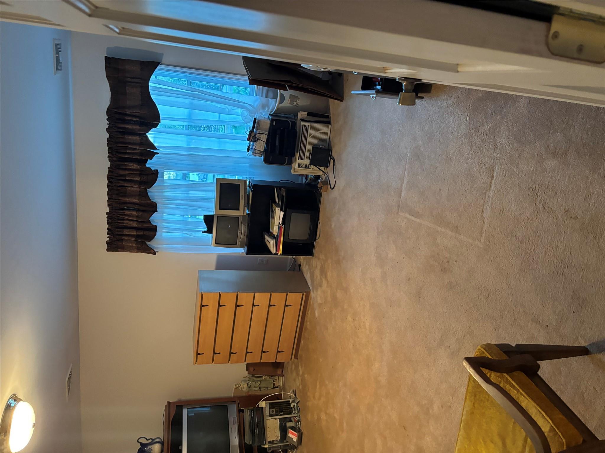 60 Randall Road Wading River, NY 11792 - Photo 7 of 14 a view of a room with furniture and a flat screen tv