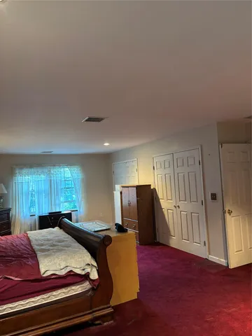 a bed room with a bed furniture and a window