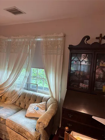 a living room with furniture and a floor to ceiling window