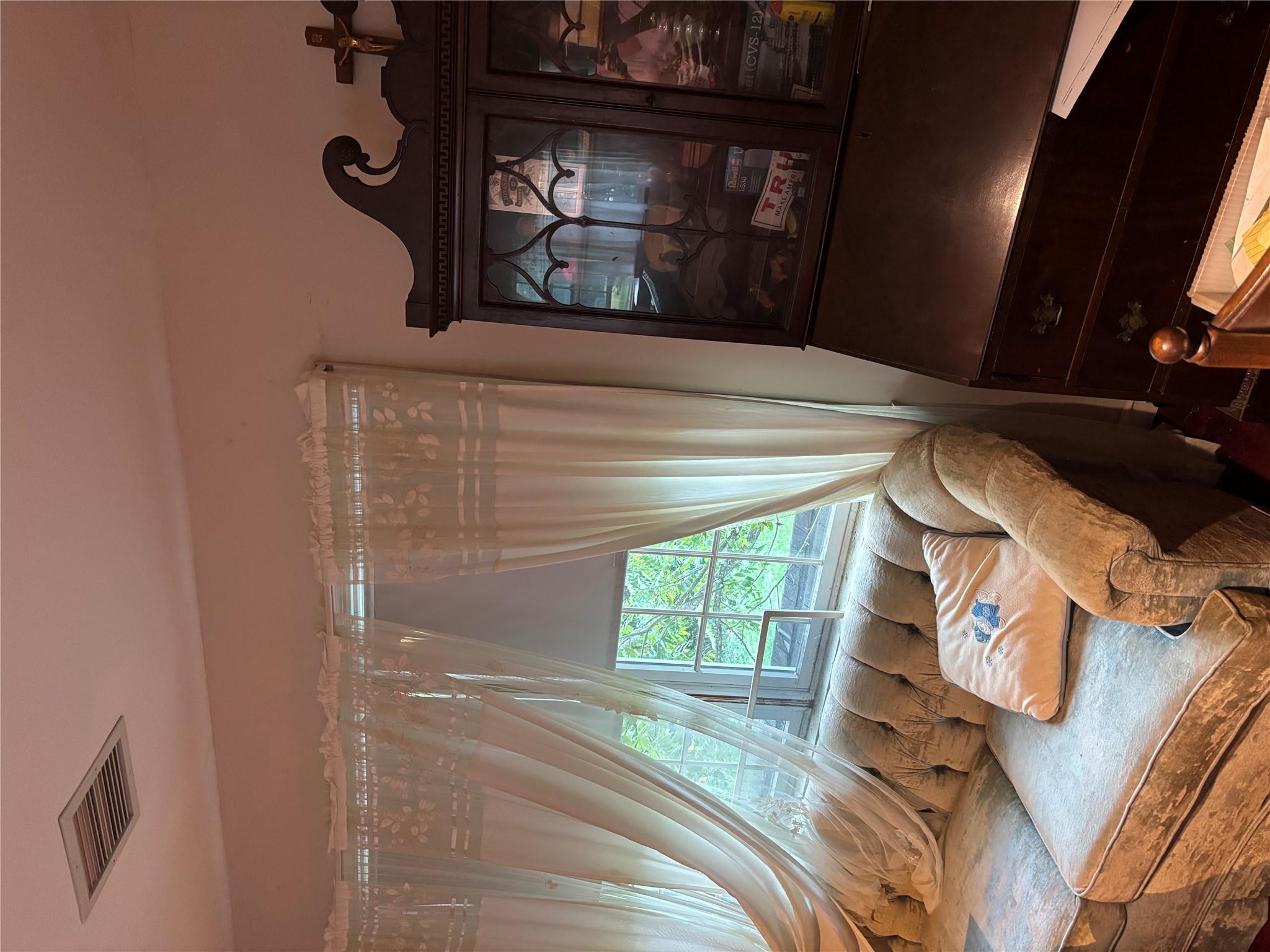 60 Randall Road Wading River, NY 11792 - Photo 10 of 14 a living room with furniture and a floor to ceiling window