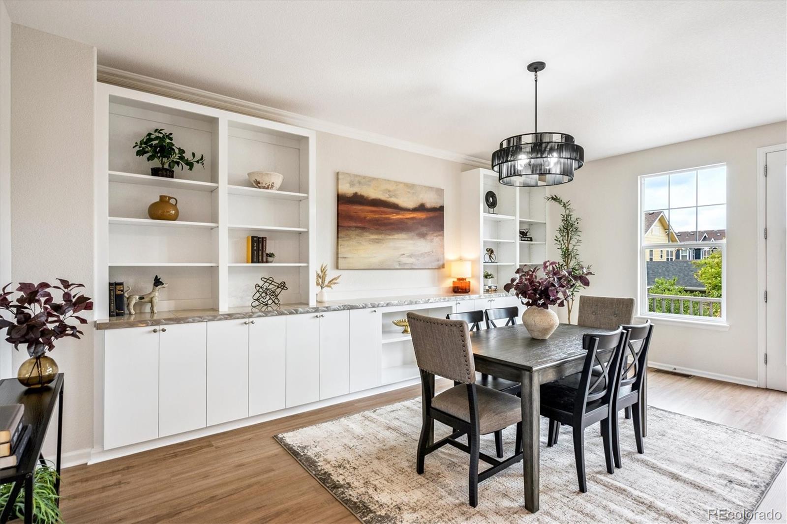 11815 Stuart Place Westminster, CO 80031 - Photo 11 of 36 a dining room with furniture a chandelier and wooden floor