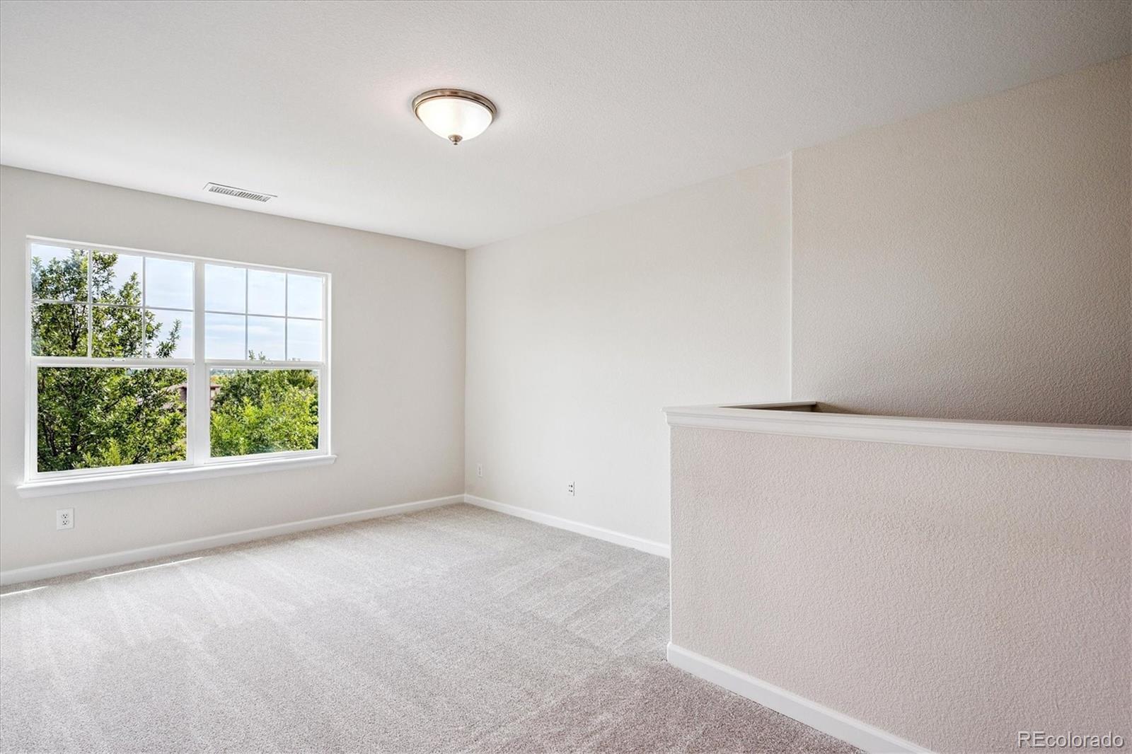 11815 Stuart Place Westminster, CO 80031 - Photo 20 of 36 an empty room with windows