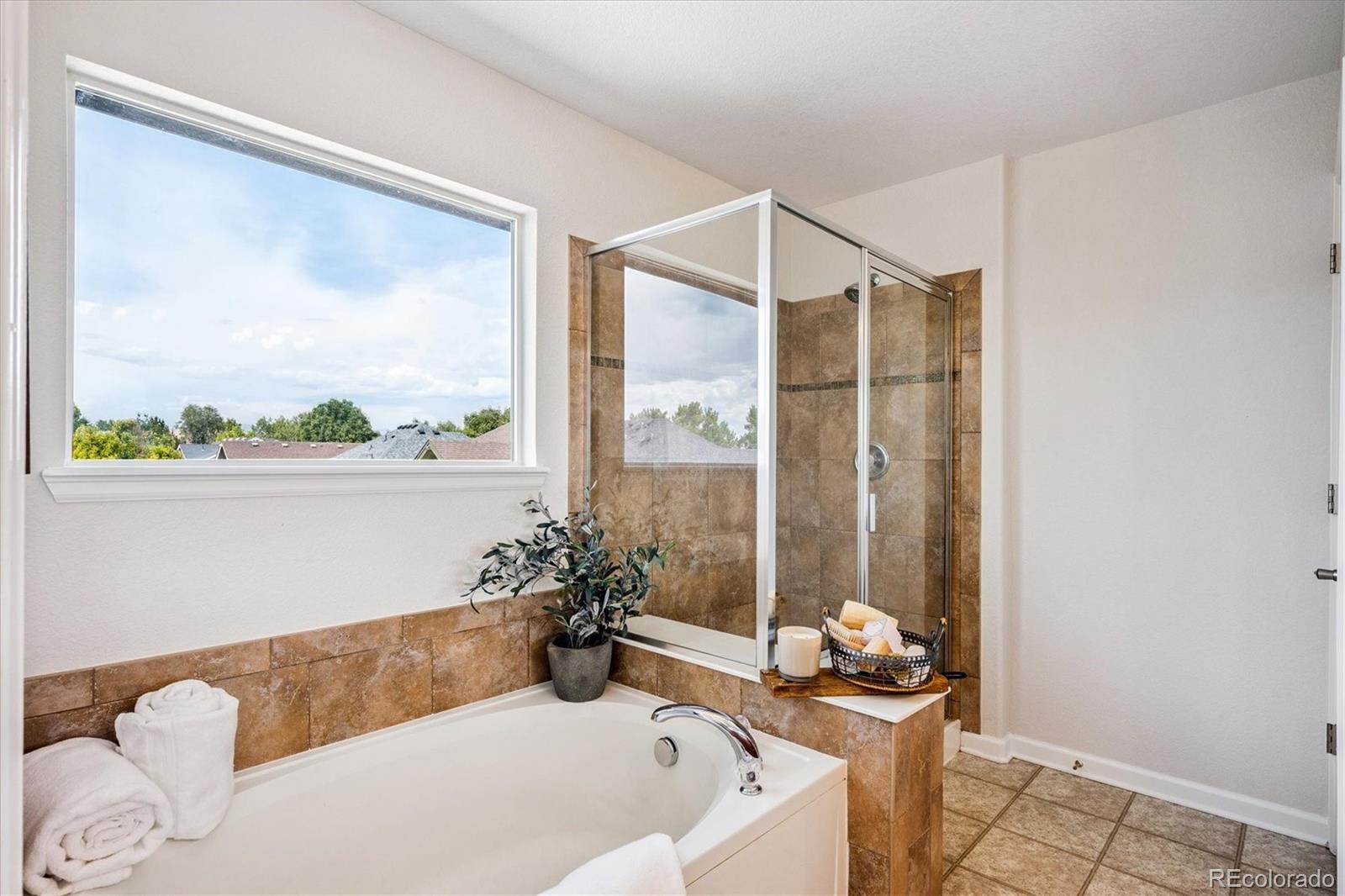 11815 Stuart Place Westminster, CO 80031 - Photo 23 of 36 a bath tub sitting in a bathroom next to a window