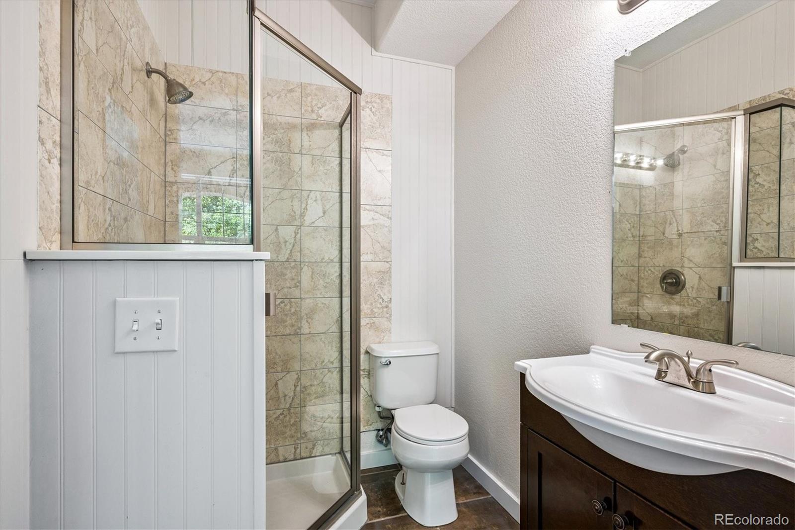 11815 Stuart Place Westminster, CO 80031 - Photo 30 of 36 a bathroom with a sink toilet and shower