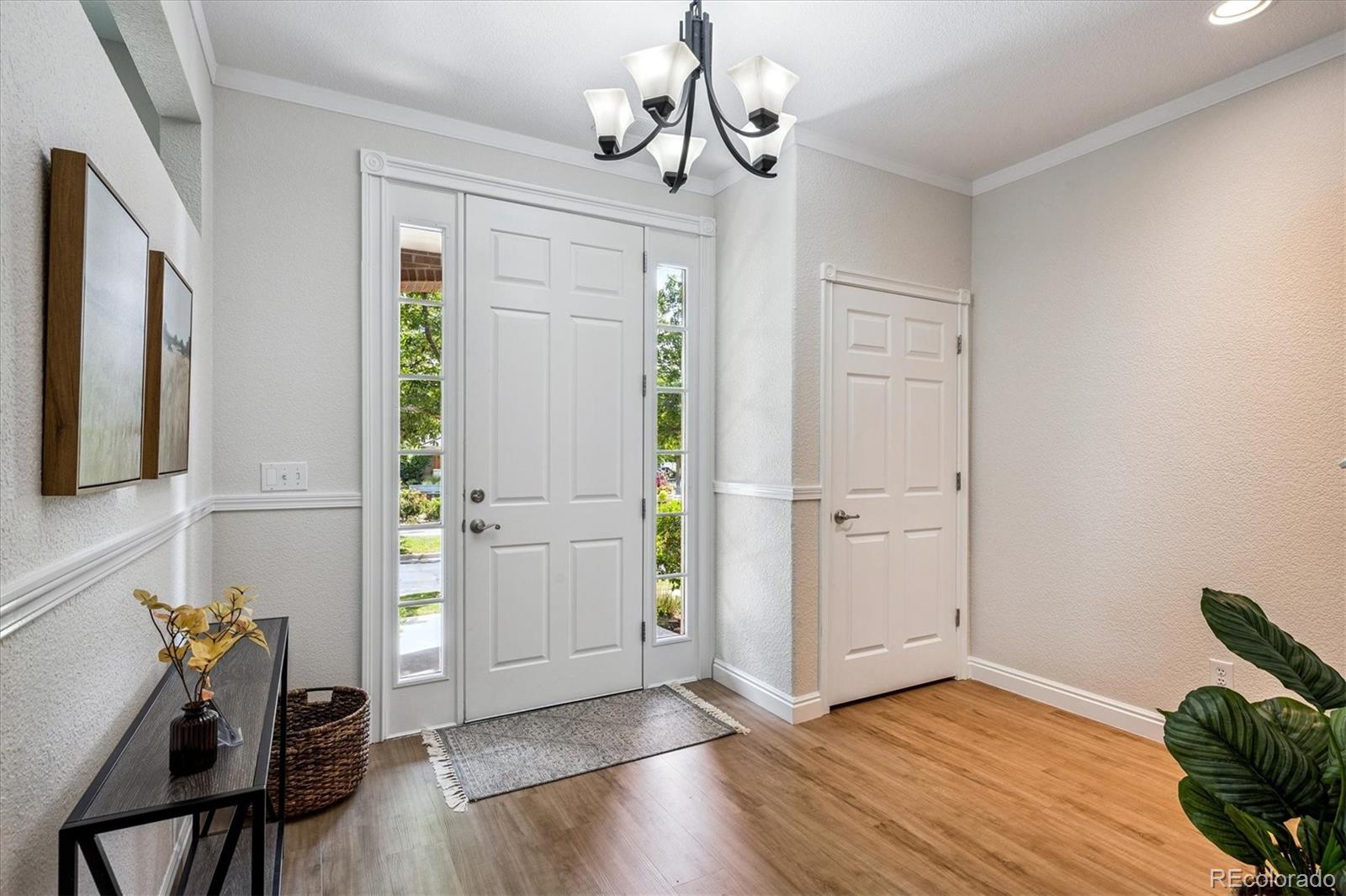 11815 Stuart Place Westminster, CO 80031 - Photo 3 of 36 a view of a livingroom with wooden floor and hallway