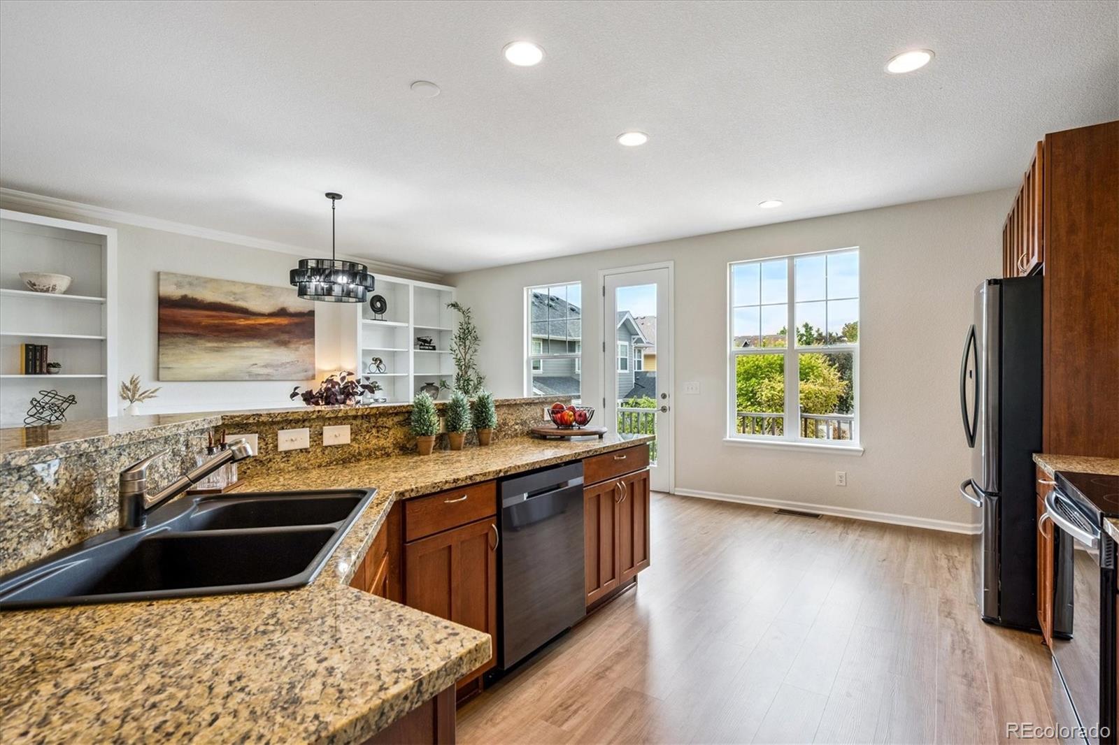 11815 Stuart Place Westminster, CO 80031 - Photo 7 of 36 a kitchen with a sink stove and refrigerator
