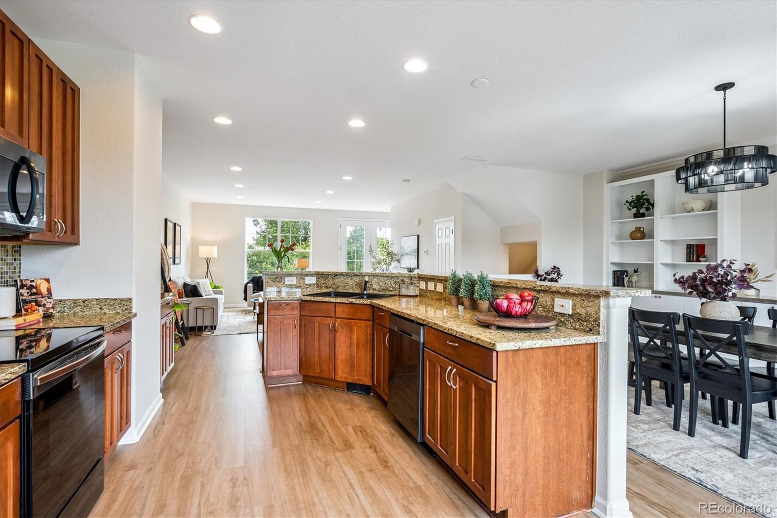 11815 Stuart Place Westminster, CO 80031 - Photo 8 of 36 a kitchen that has a lot of cabinets a sink and appliances in it