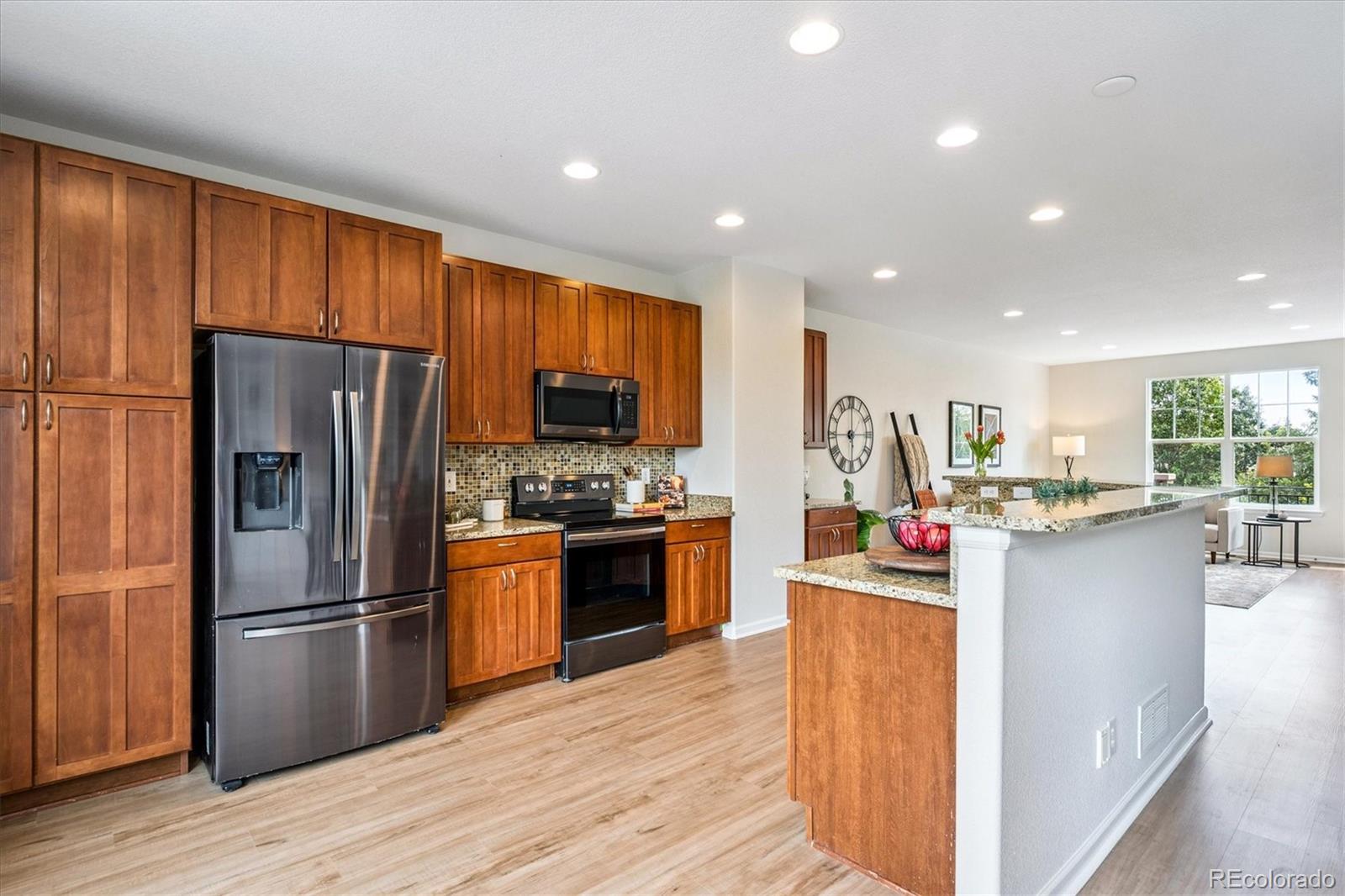 11815 Stuart Place Westminster, CO 80031 - Photo 9 of 36 a kitchen with stainless steel appliances granite countertop a refrigerator stove and oven