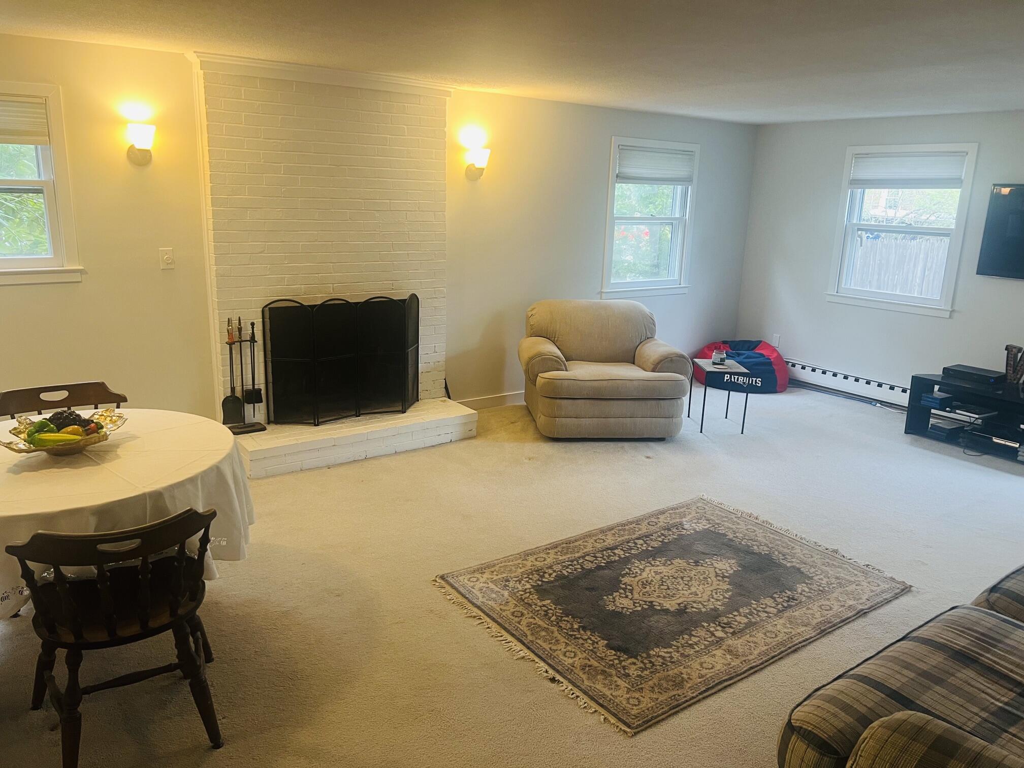 1431 Iyannough Road, Unit 1 Centerville, MA 02632 - Photo 19 of 28 a living room with furniture and a table