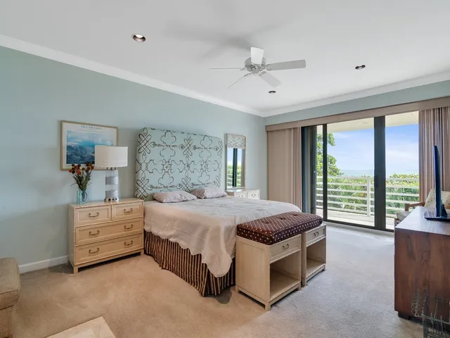 a spacious bedroom with a bed and large windows