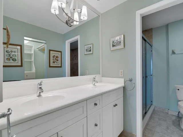a bathroom with a sink double vanity and a mirror