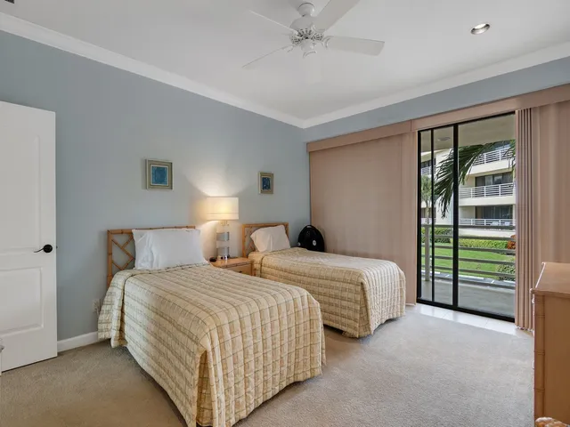 a bedroom with two beds and a chandelier
