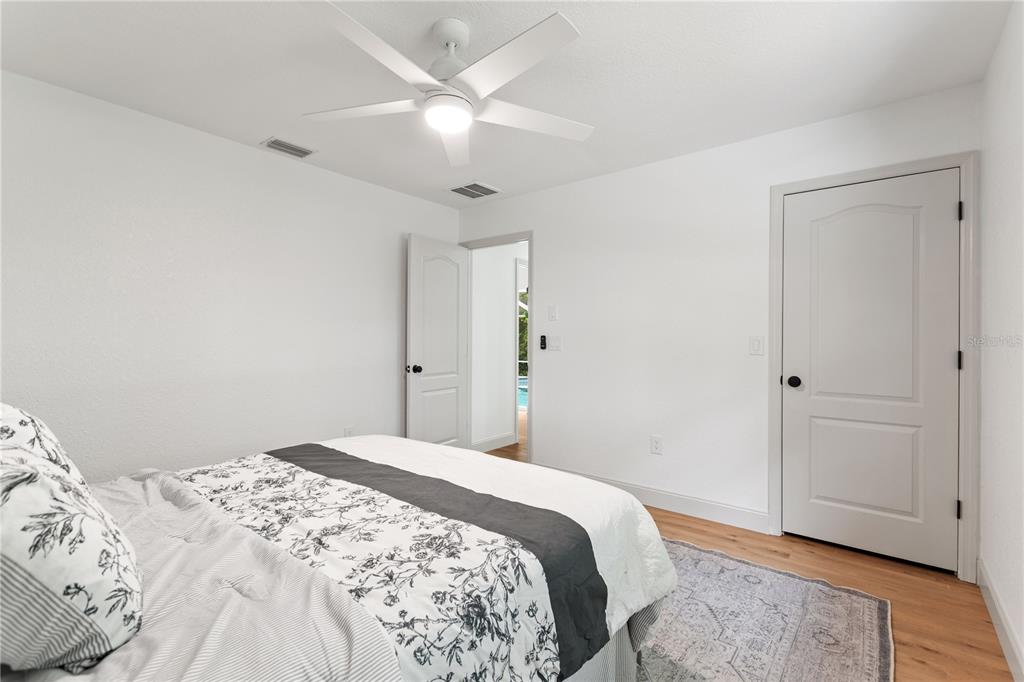419 Silas Court Spring Hill, FL 34609 - Photo 37 of 56 a bedroom with a bed and a chandelier