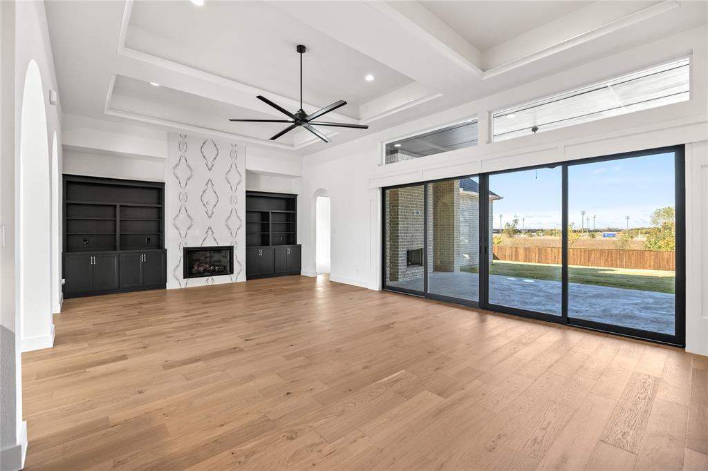 229 Bel Grand Road Haslet, TX 76052 - Photo 16 of 37 an empty room with large windows and a ceiling fan