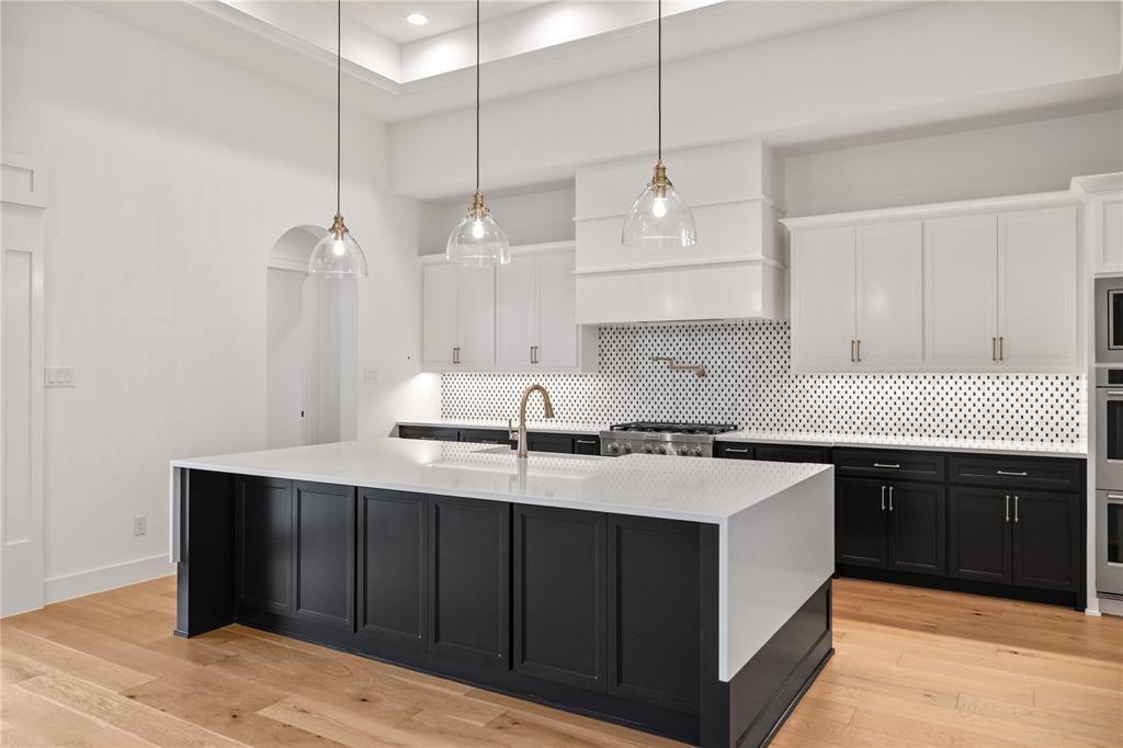 229 Bel Grand Road Haslet, TX 76052 - Photo 18 of 37 a kitchen with a sink a stove and cabinets