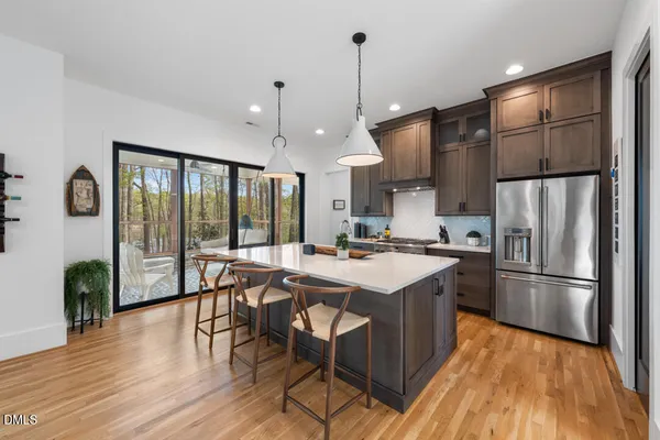 a large kitchen with a table and chairs