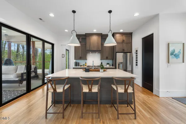 a kitchen with stainless steel appliances a stove a refrigerator and cabinets
