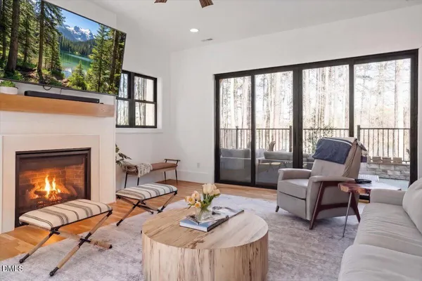 a living room with furniture a fireplace and a flat screen tv