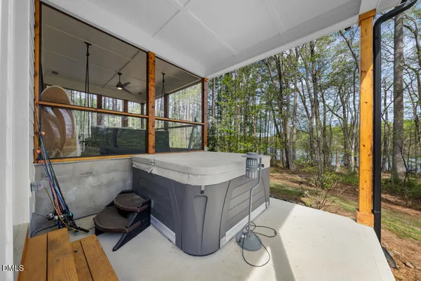a view of a patio with a table and chairs and floor to ceiling window
