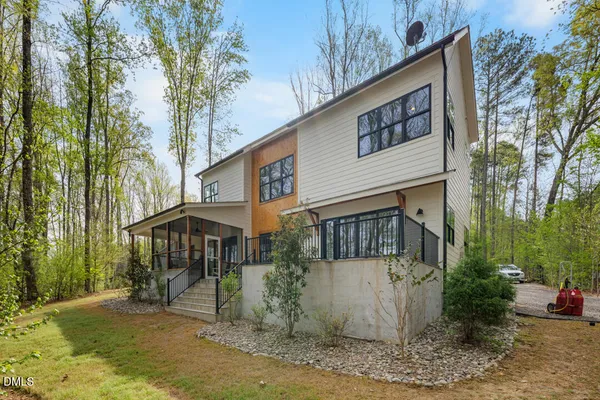 a living room with couches and large trees