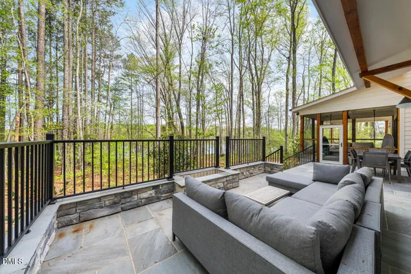 a balcony with furniture and a potted plant