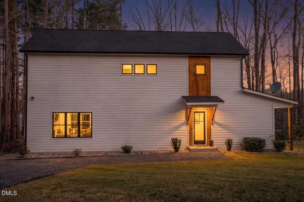 a view of a house with potted plants