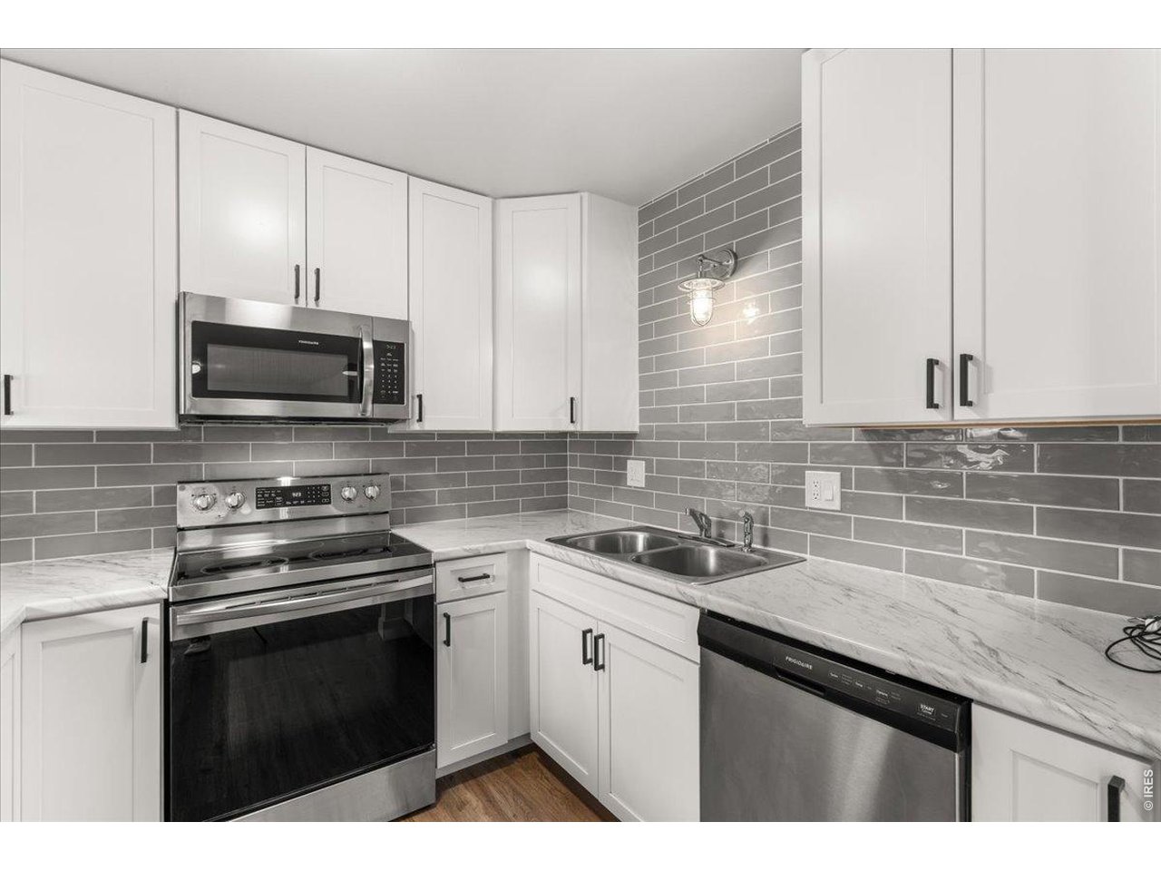 1625 West Elizabeth Street, Unit 2 Fort Collins, CO 80521 - Photo 11 of 29 a kitchen with stainless steel appliances a sink stove and microwave