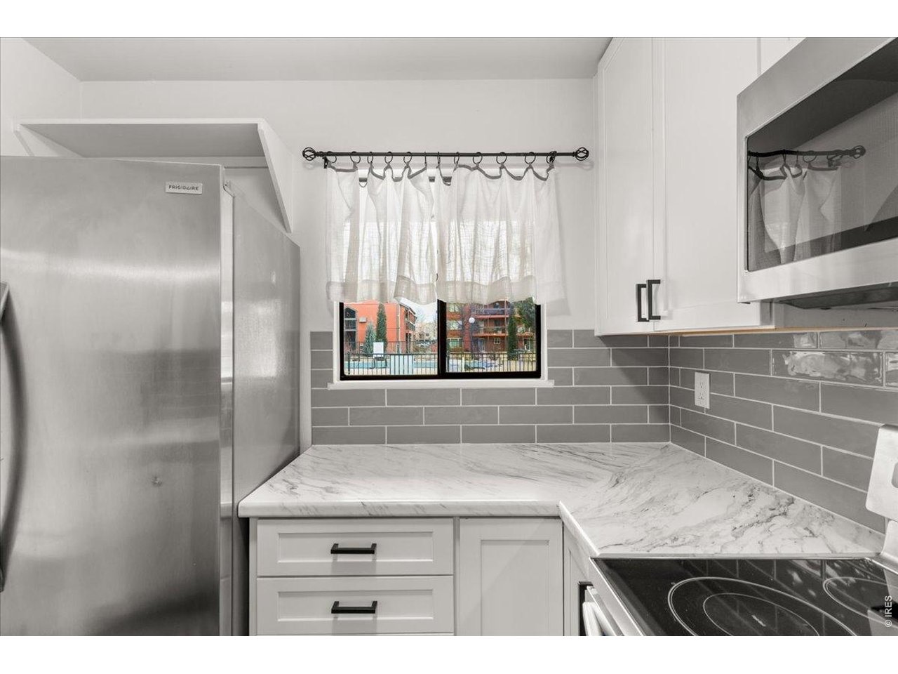 1625 West Elizabeth Street, Unit 2 Fort Collins, CO 80521 - Photo 12 of 29 a sink with granite countertop a sink and a refrigerator