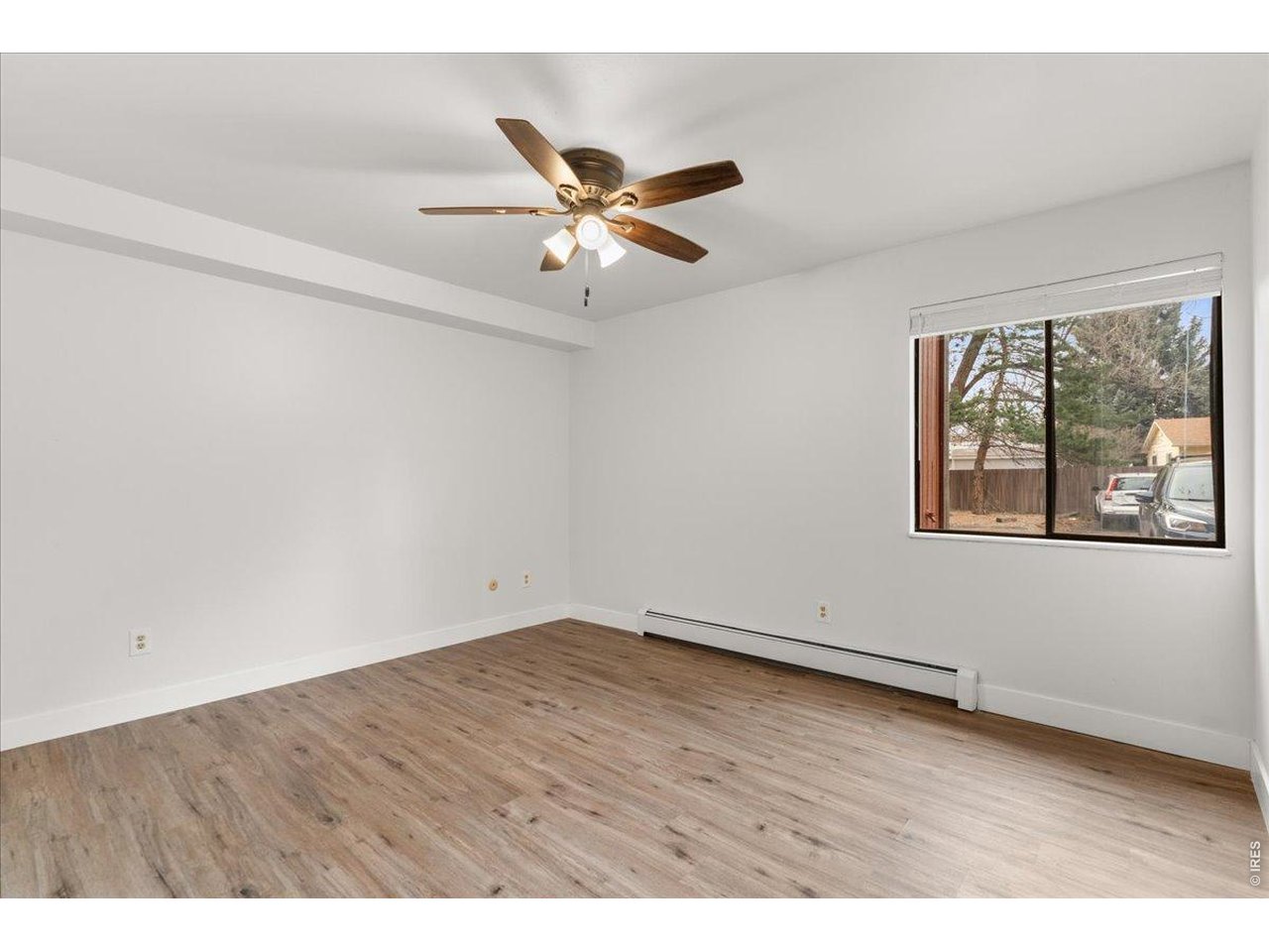 1625 West Elizabeth Street, Unit 2 Fort Collins, CO 80521 - Photo 16 of 29 an empty room with wooden floor fan and windows