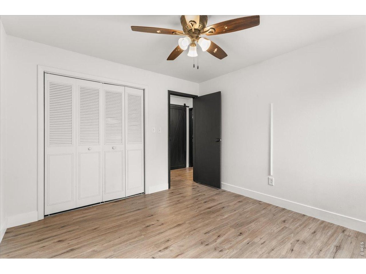 1625 West Elizabeth Street, Unit 2 Fort Collins, CO 80521 - Photo 17 of 29 an empty room with wooden floor and windows