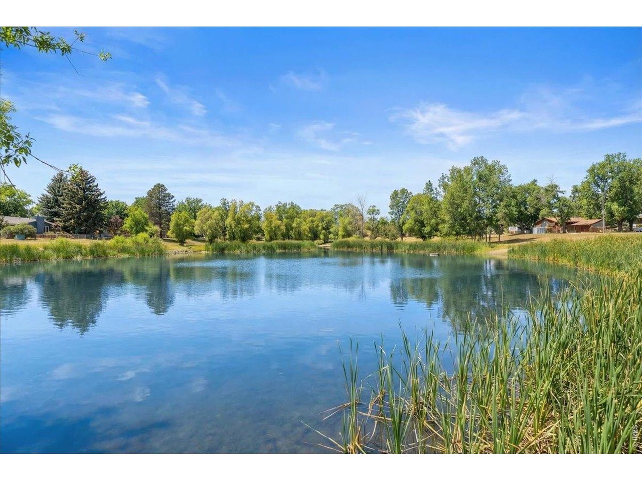 1625 West Elizabeth Street, Unit 2 Fort Collins, CO 80521 - Photo 26 of 29 a view of a lake with houses in the background