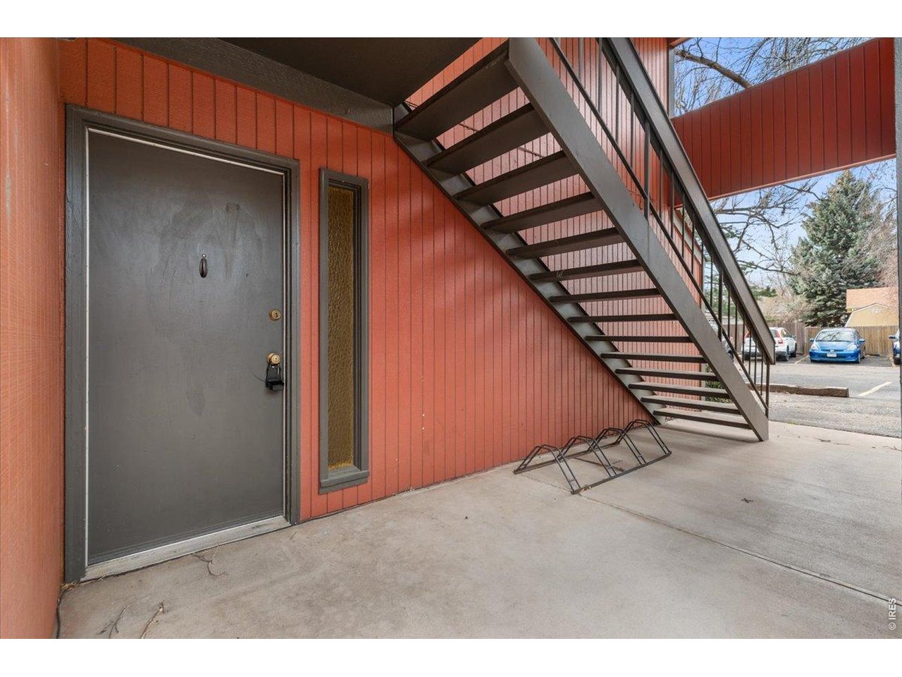 1625 West Elizabeth Street, Unit 2 Fort Collins, CO 80521 - Photo 3 of 29 a view of an empty room with wooden floor and stairs
