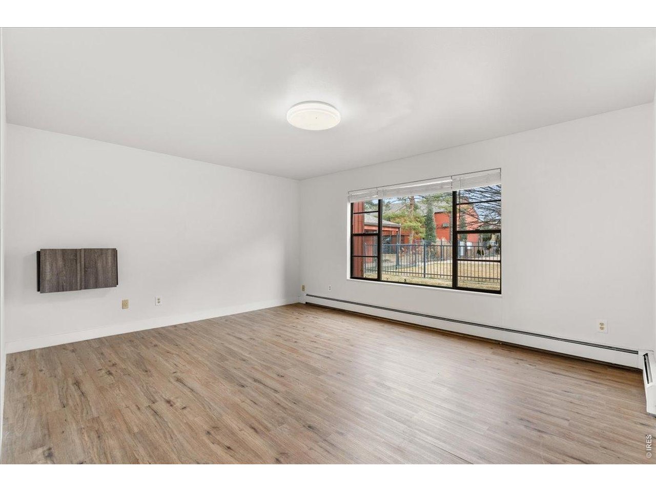 1625 West Elizabeth Street, Unit 2 Fort Collins, CO 80521 - Photo 5 of 29 an empty room with wooden floor and windows