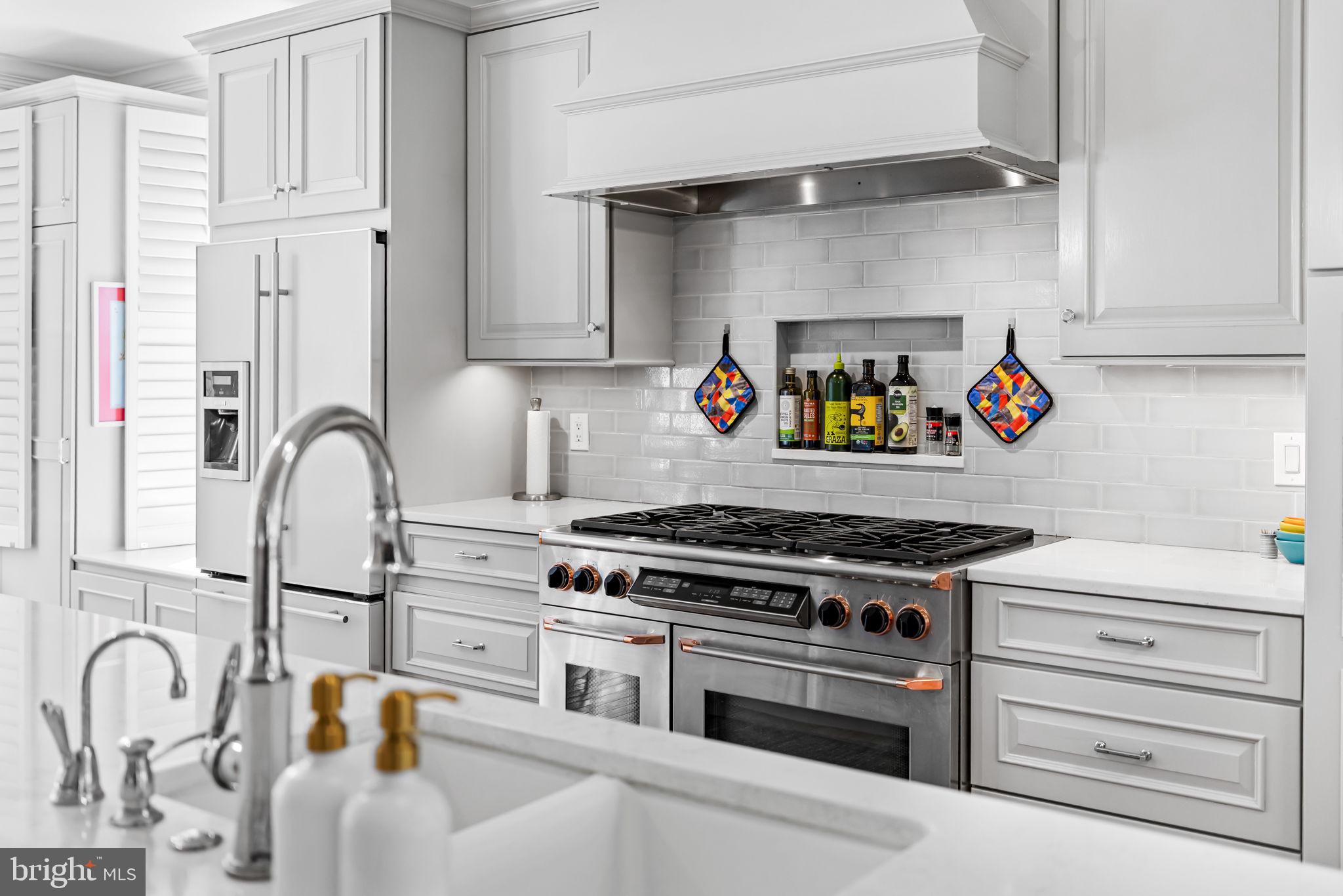 2331 Boston Street, Unit 1 Baltimore, MD 21224 - Photo 33 of 74 a kitchen with white cabinets and appliances