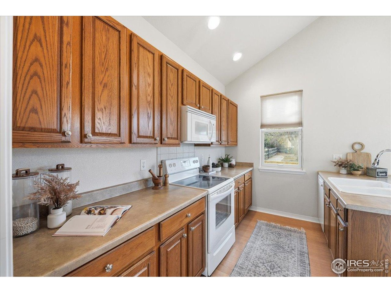 2287 Trestle Road Fort Collins, CO 80525 - Photo 17 of 40 a kitchen with stainless steel appliances granite countertop a sink stove and cabinets