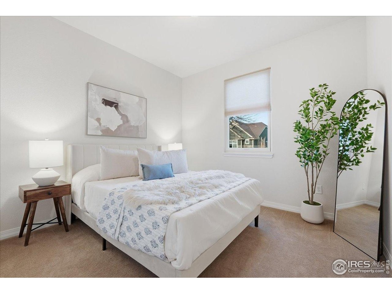 2287 Trestle Road Fort Collins, CO 80525 - Photo 28 of 40 a bedroom with a bed and a potted plant