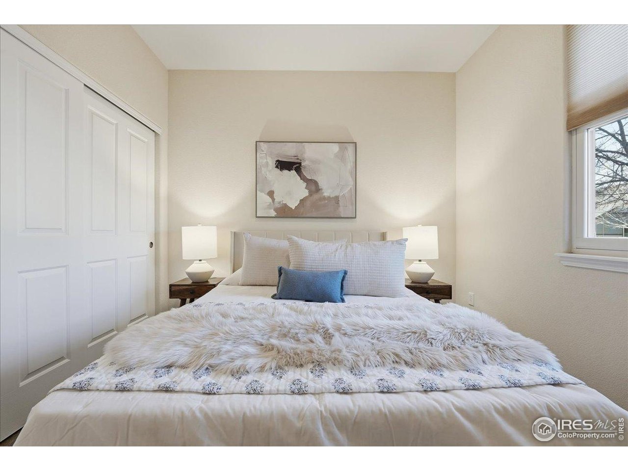 2287 Trestle Road Fort Collins, CO 80525 - Photo 29 of 40 a bedroom with a bed and a painting on the wall