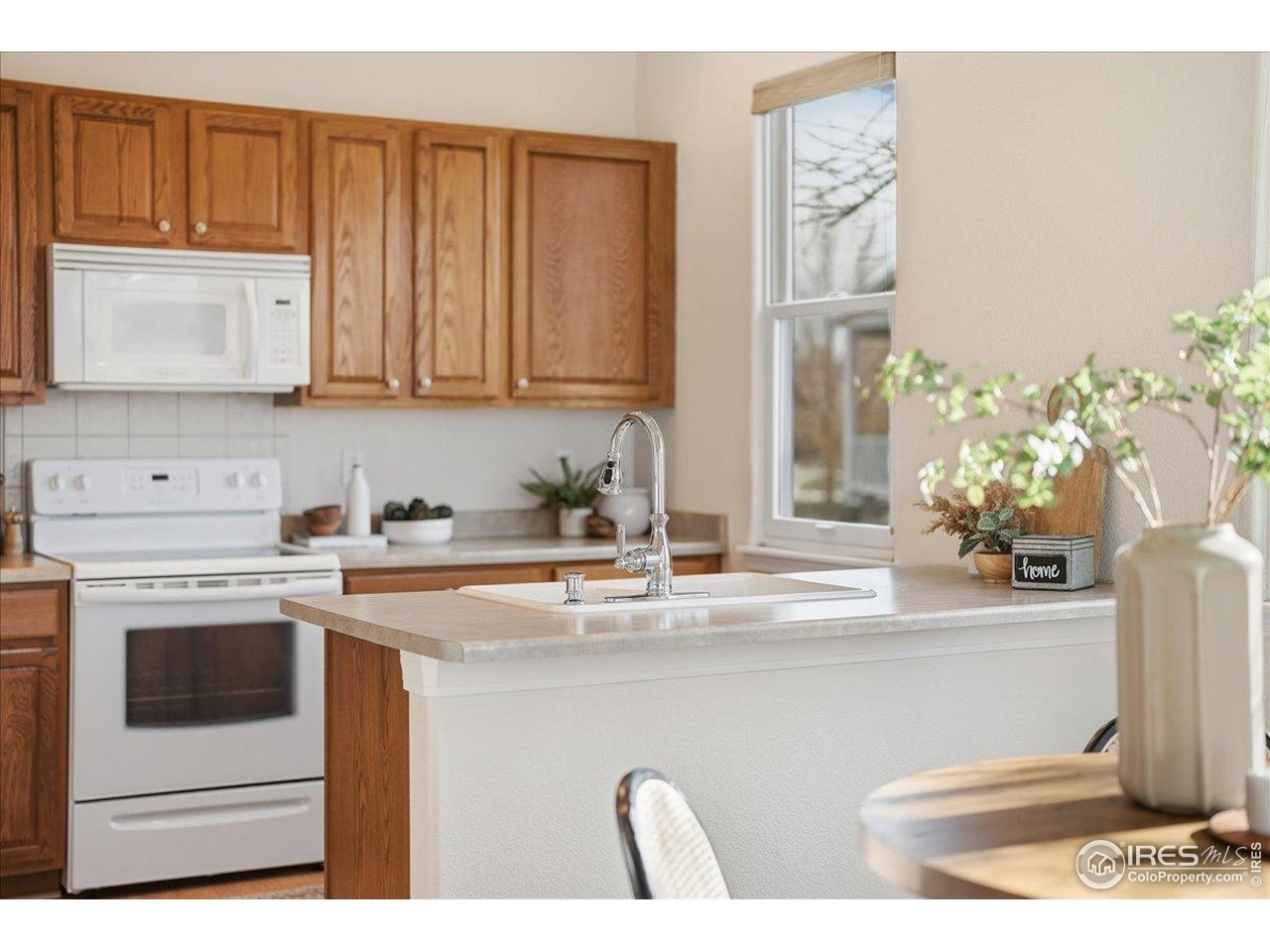 2287 Trestle Road Fort Collins, CO 80525 - Photo 3 of 40 a kitchen with stainless steel appliances granite countertop a sink a stove and a microwave