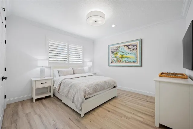 a view of bedroom with natural light and wooden floor