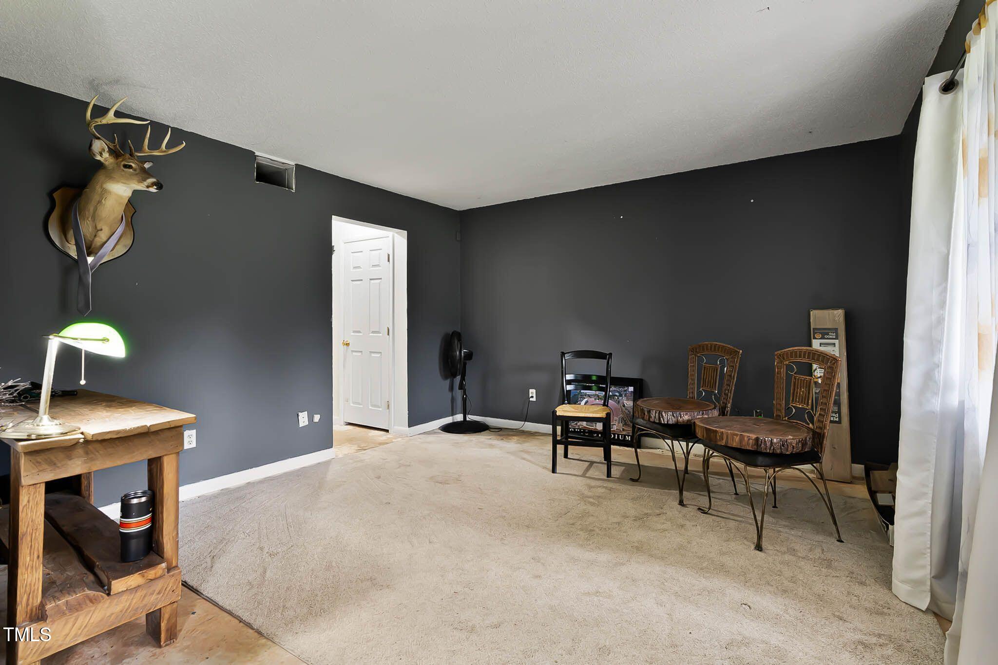 5931 Farm Gate Road Raleigh, NC 27606 - Photo 29 of 37 a view of a workspace with furniture and a fireplace